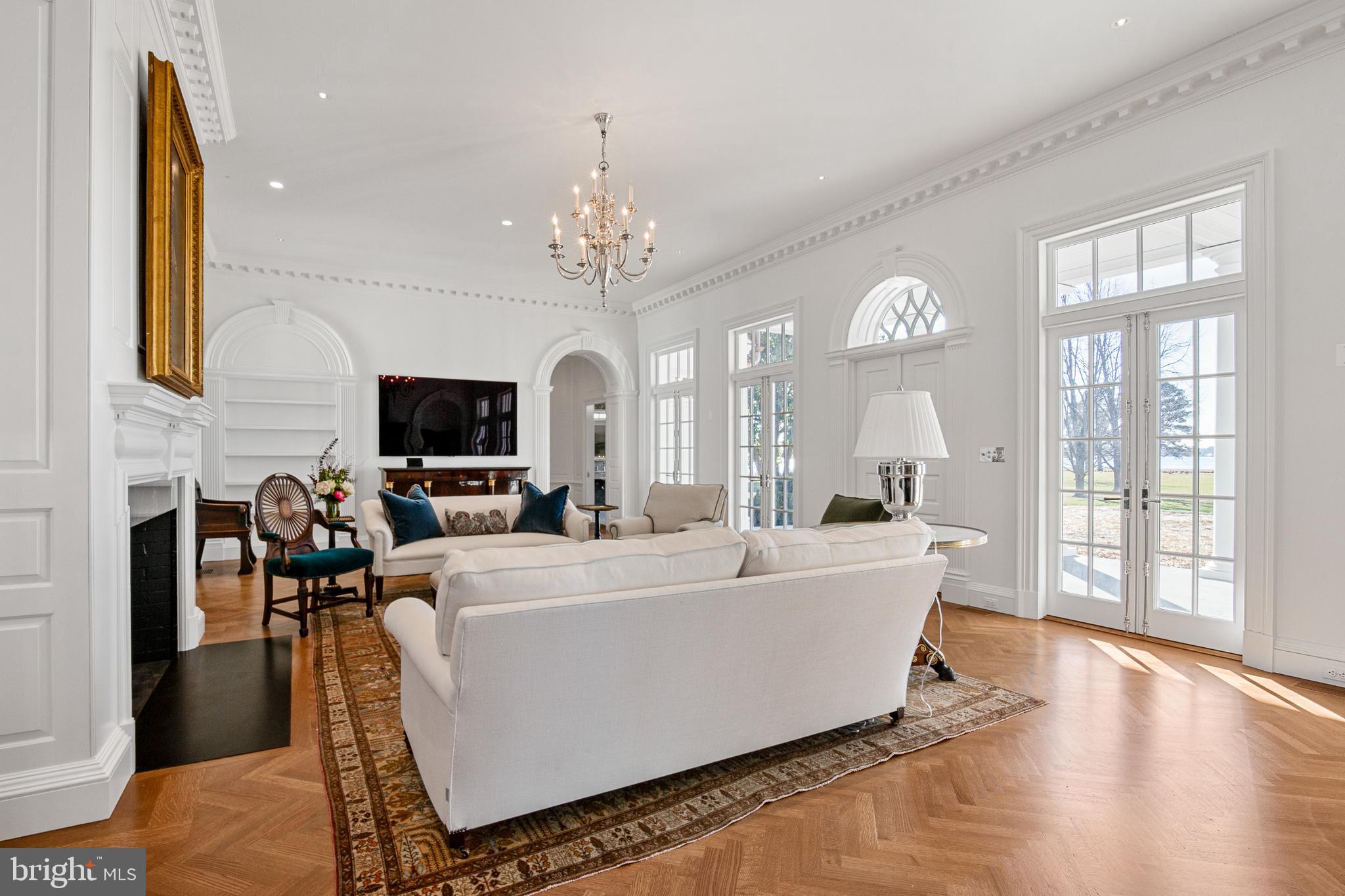 6010 Shipyard Lane Easton, MD 21601 - Photo 16 of 71 a living room with fireplace furniture and a chandelier