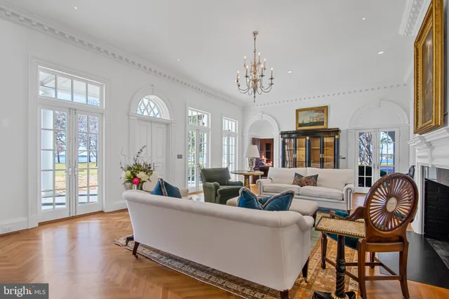 a kitchen with stainless steel appliances granite countertop a sink a stove a refrigerator and island with wooden floor