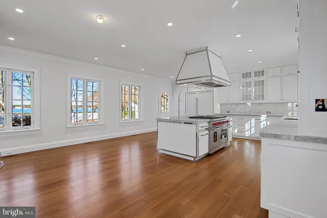 a kitchen with granite countertop white cabinets and window