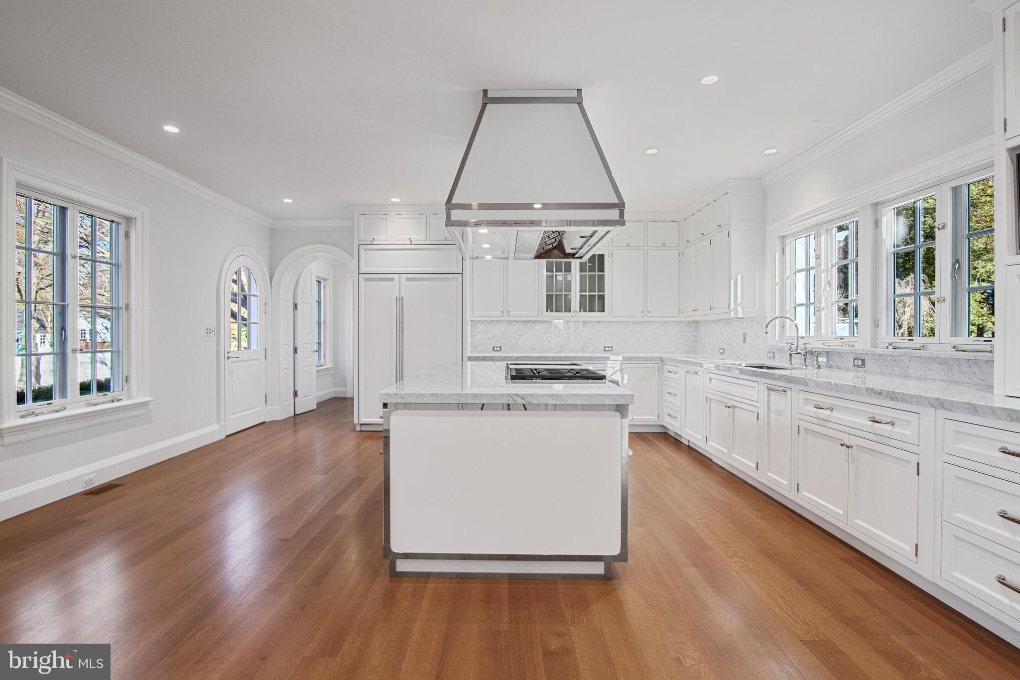 6010 Shipyard Lane Easton, MD 21601 - Photo 22 of 71 a kitchen with stainless steel appliances granite countertop a sink a stove a refrigerator and island with wooden floor