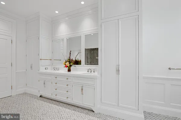 a spacious bathroom with a granite countertop sink and a mirror