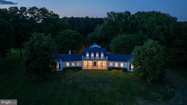 a living room with fireplace furniture and a chandelier