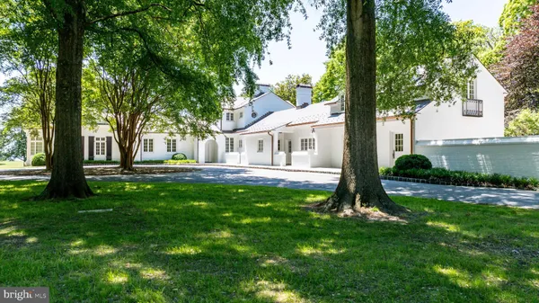 a living room with furniture a fireplace and a large mirror