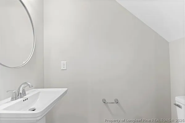 a view of a hallway with wooden floor and entryway