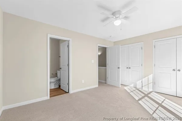 a bathroom with a double vanity sink mirror and toilet