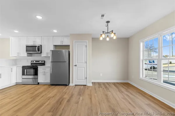 a kitchen that has a sink stainless steel appliances and cabinets