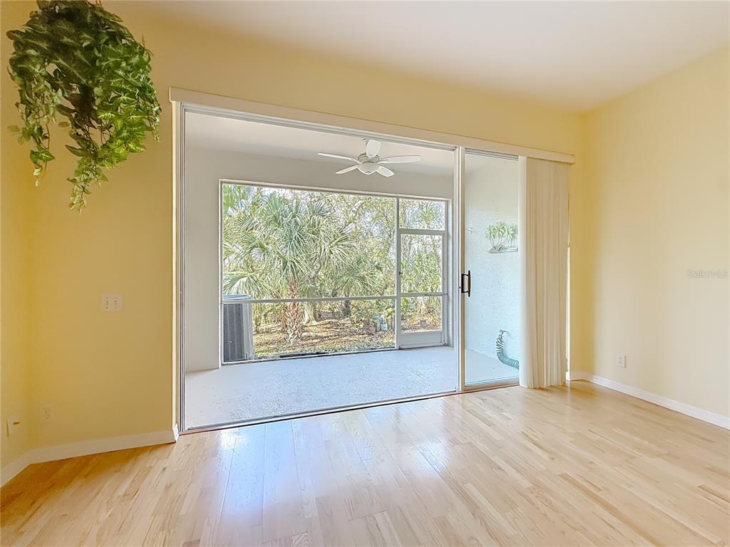 3589 Country Pointe Place Palm Harbor, FL 34684 - Photo 11 of 31 an empty room with wooden floor and windows