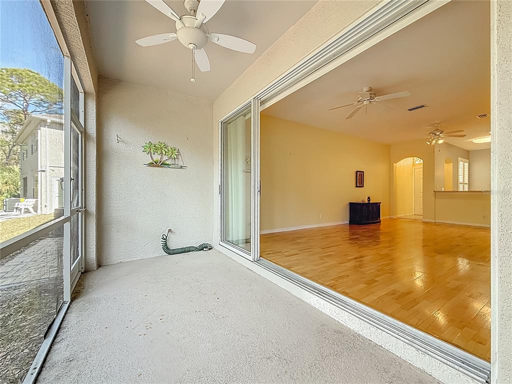 3589 Country Pointe Place Palm Harbor, FL 34684 - Photo 13 of 31 a view of a livingroom with a chandelier and a ceiling fan