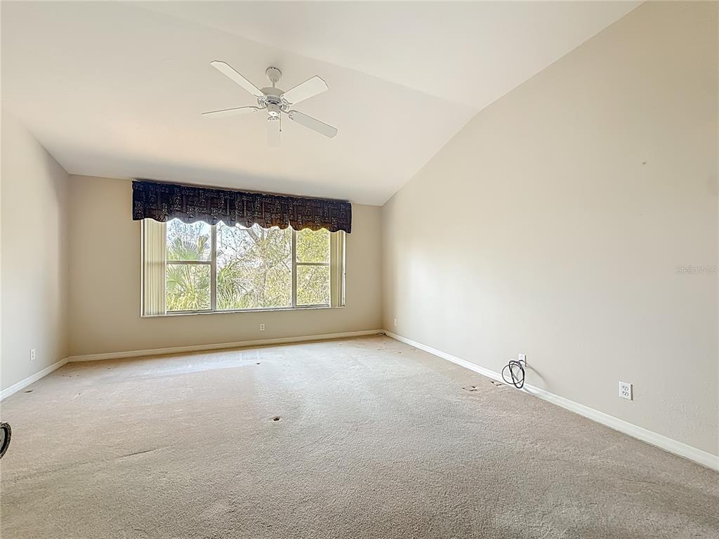 3589 Country Pointe Place Palm Harbor, FL 34684 - Photo 18 of 31 an empty room with a window and a ceiling fan