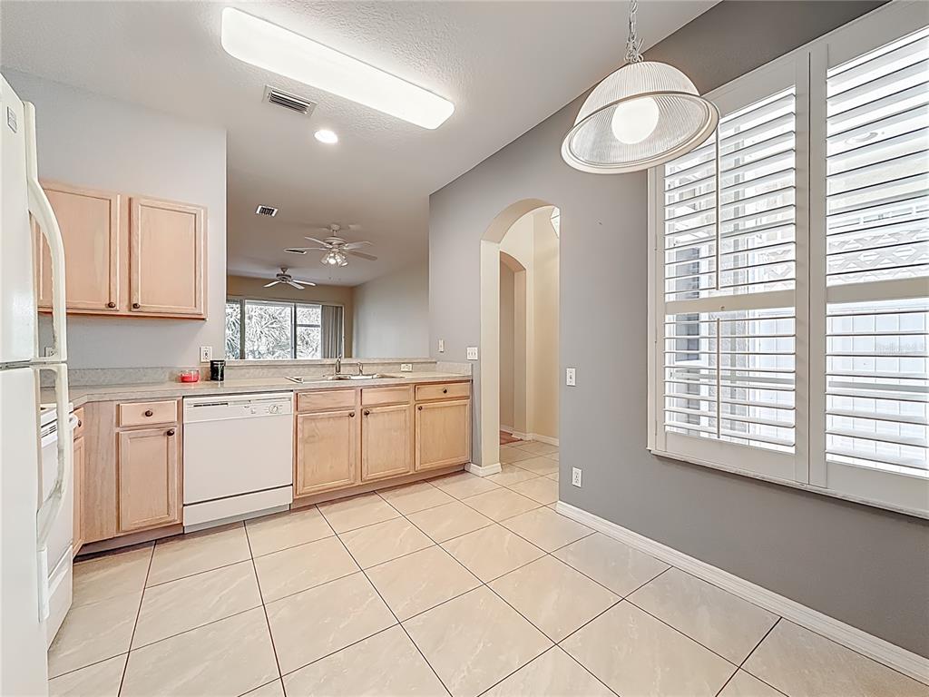 3589 Country Pointe Place Palm Harbor, FL 34684 - Photo 5 of 31 a kitchen with a white cabinets and window