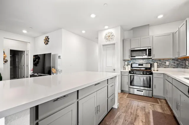 a kitchen with a sink and stainless steel appliances