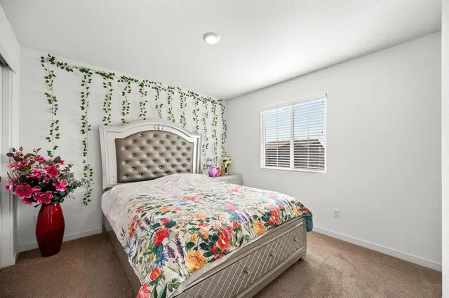 a bedroom with a bed and a potted plant