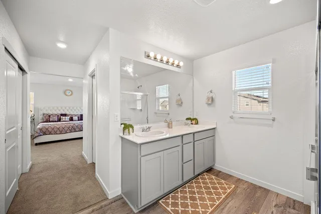 a en suite bathroom with a double sink and mirror