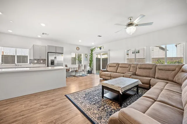 a living room with furniture and kitchen view