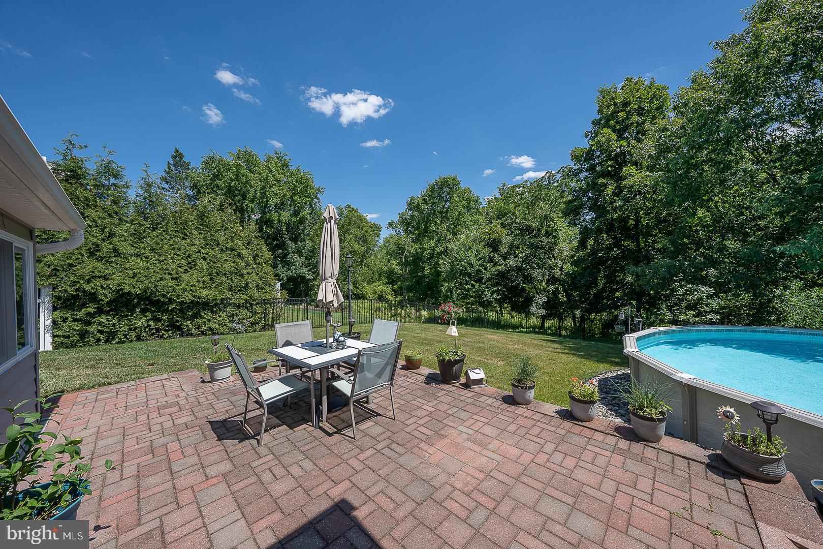 848 Mourning Dove Road Audubon, PA 19403 - Photo 63 of 86 a view of a swimming pool with lawn chairs and plants