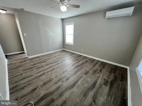wooden floor in an empty room with a window