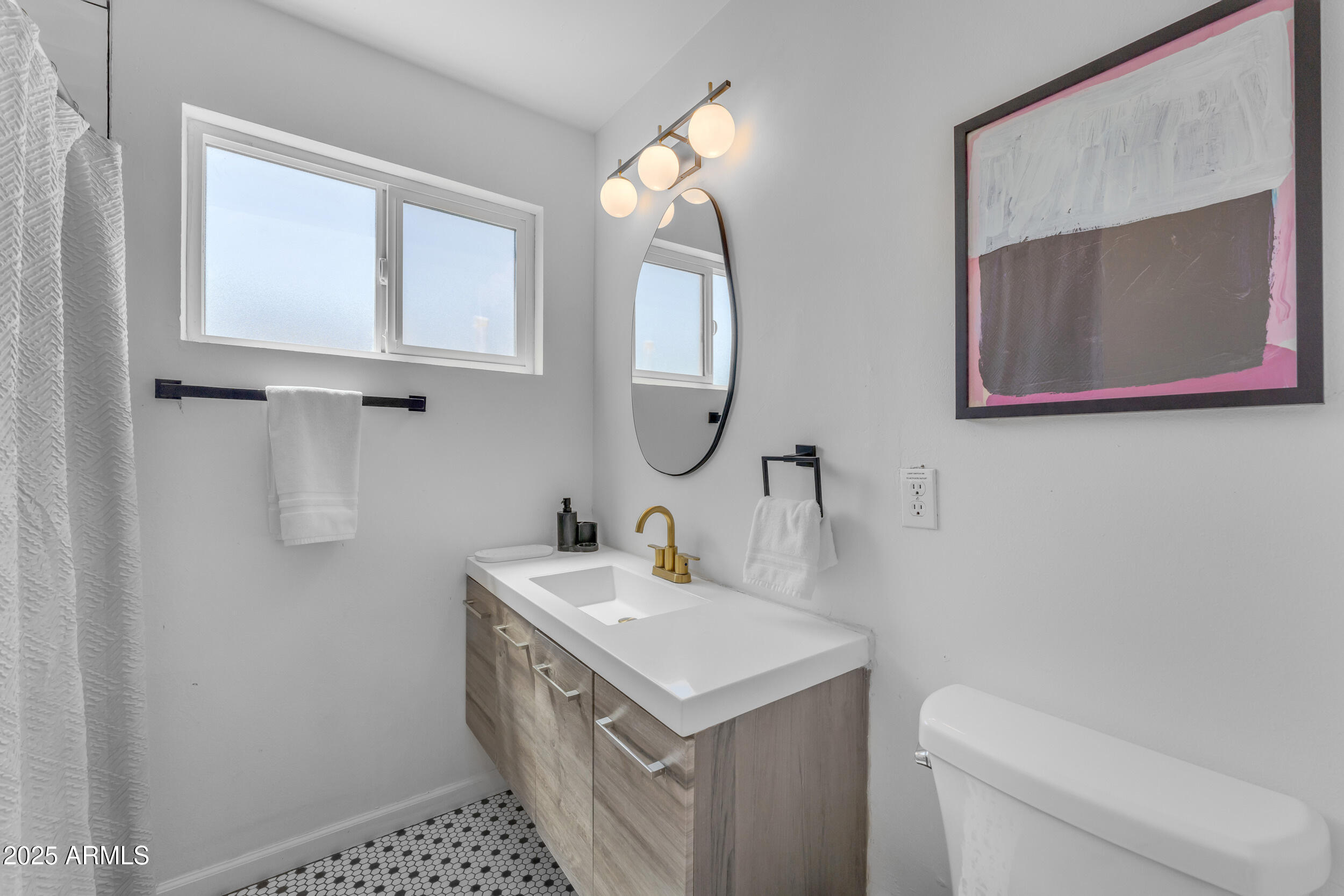 6943 East Granada Road Scottsdale, AZ 85257 - Photo 13 of 19 a bathroom with a sink toilet and mirror