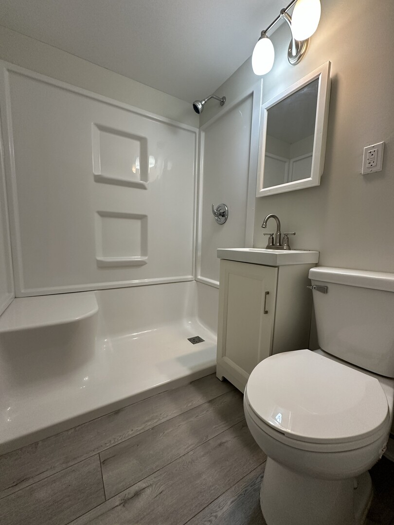 3543 William Street Steger, IL 60475 - Photo 16 of 22 a bathroom with a toilet a sink a mirror and bathtub