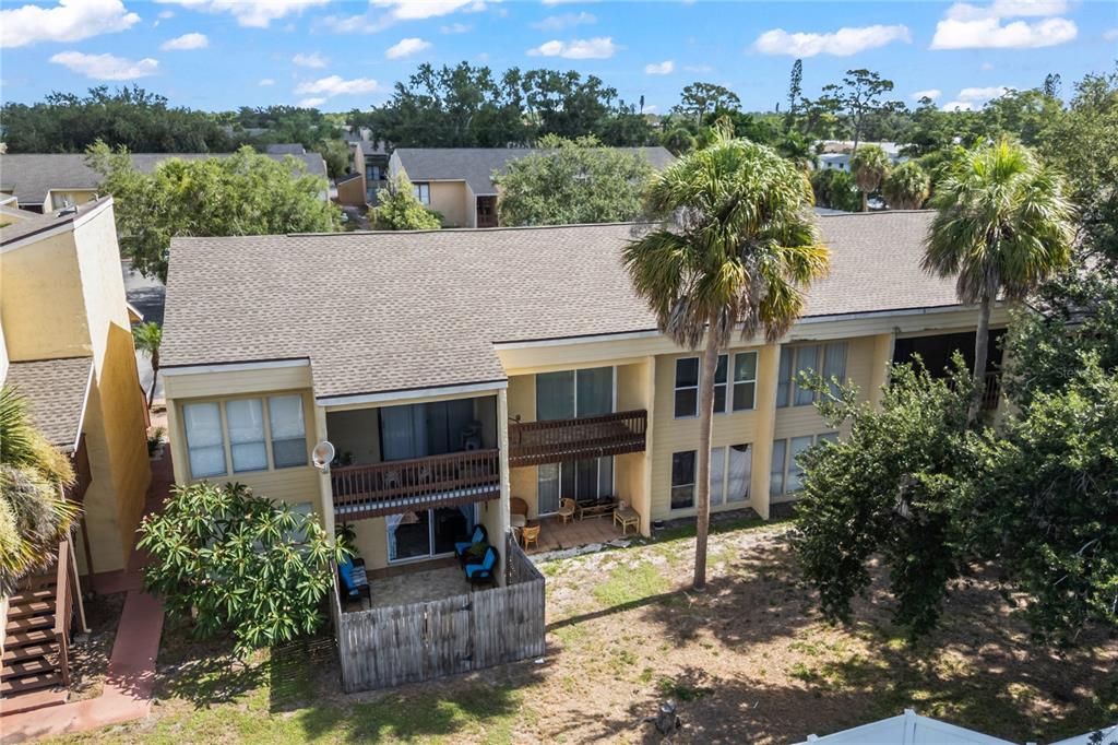 3405 Clark Road, Unit 205 Sarasota, FL 34231 - Photo 25 of 28 an aerial view of a house with a yard and a large tree