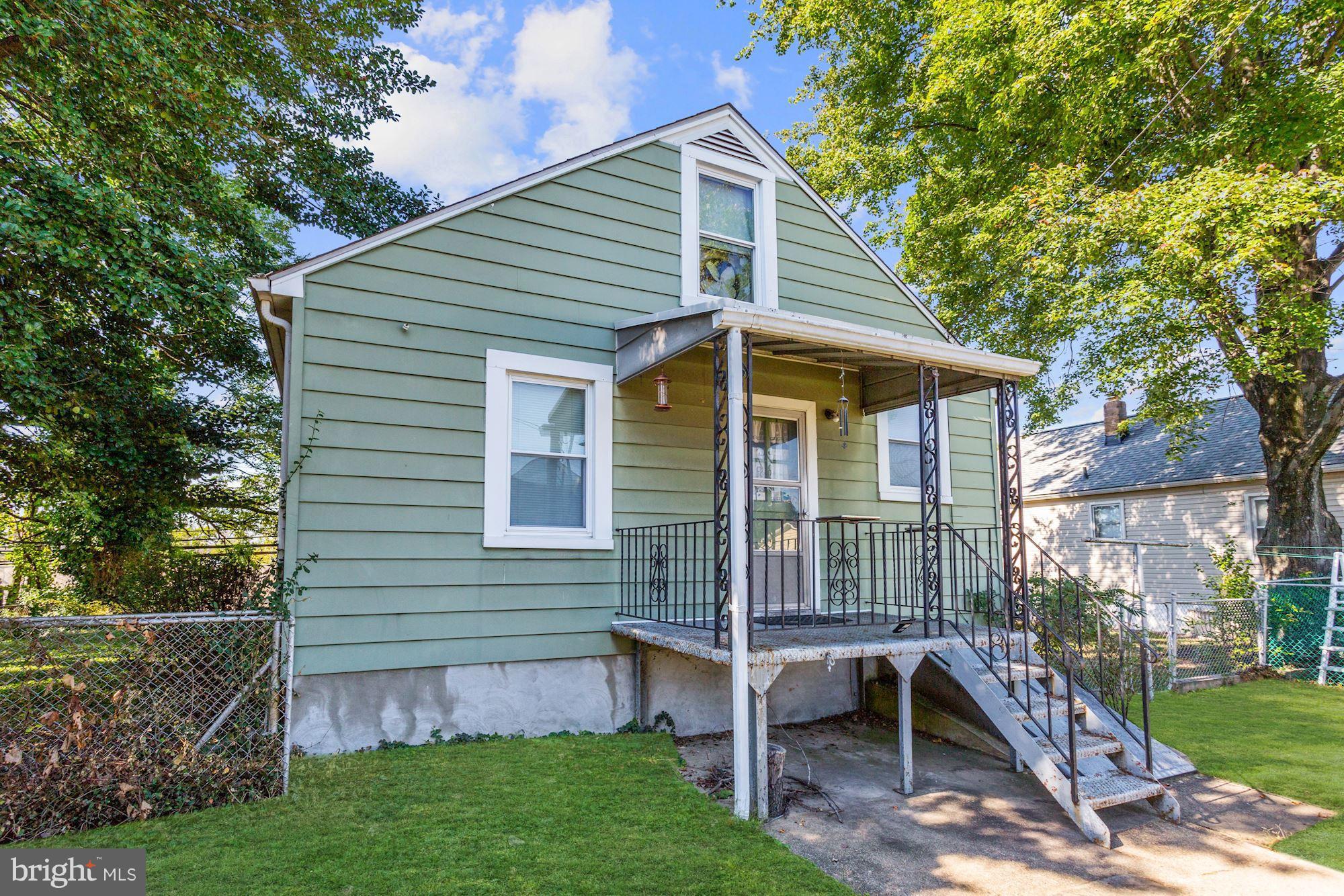 4613 Annapolis Road Baltimore, MD 21227 - Photo 14 of 15 a front view of house with a garden and patio