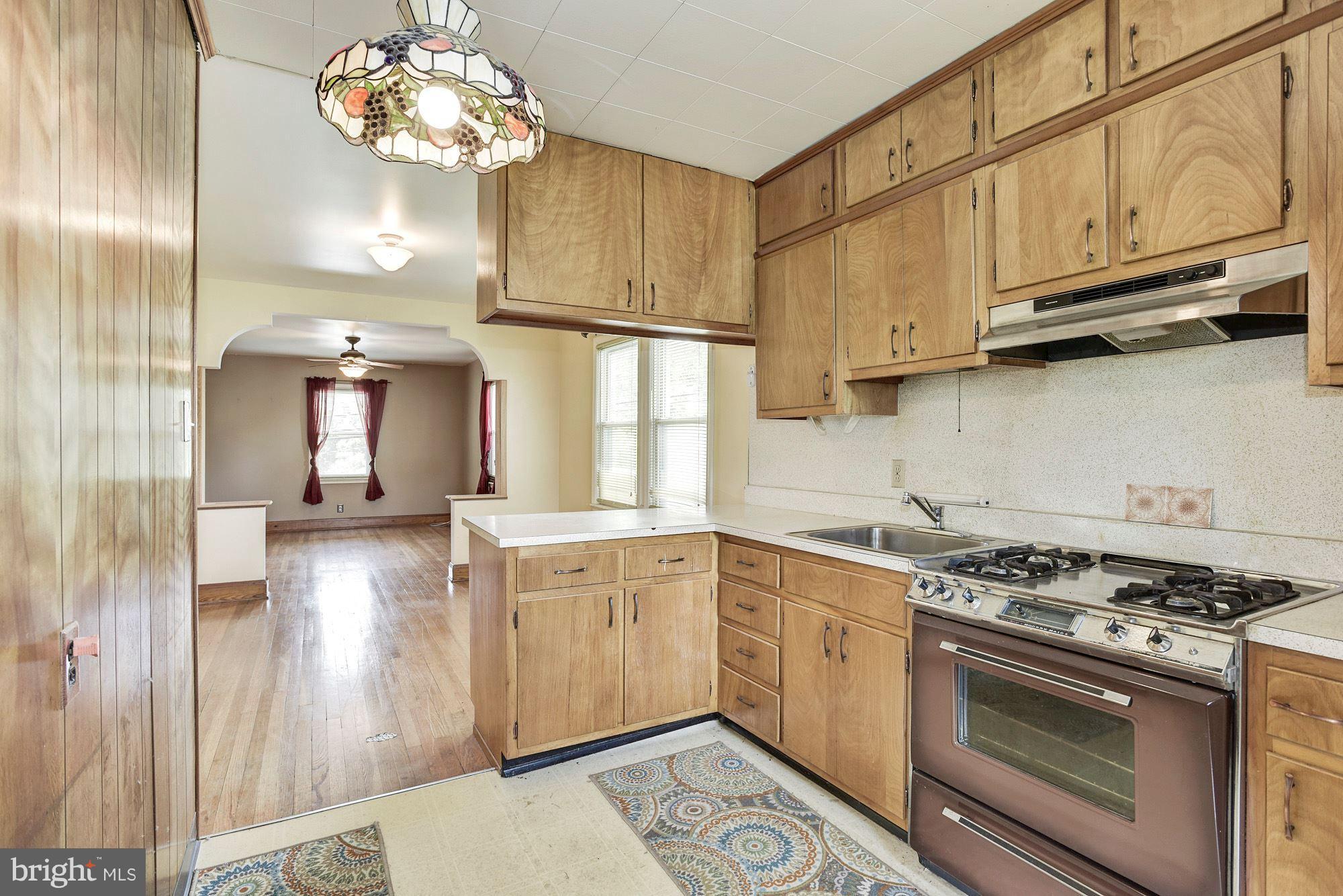 4613 Annapolis Road Baltimore, MD 21227 - Photo 7 of 15 a kitchen with stainless steel appliances granite countertop a stove a sink and a refrigerator