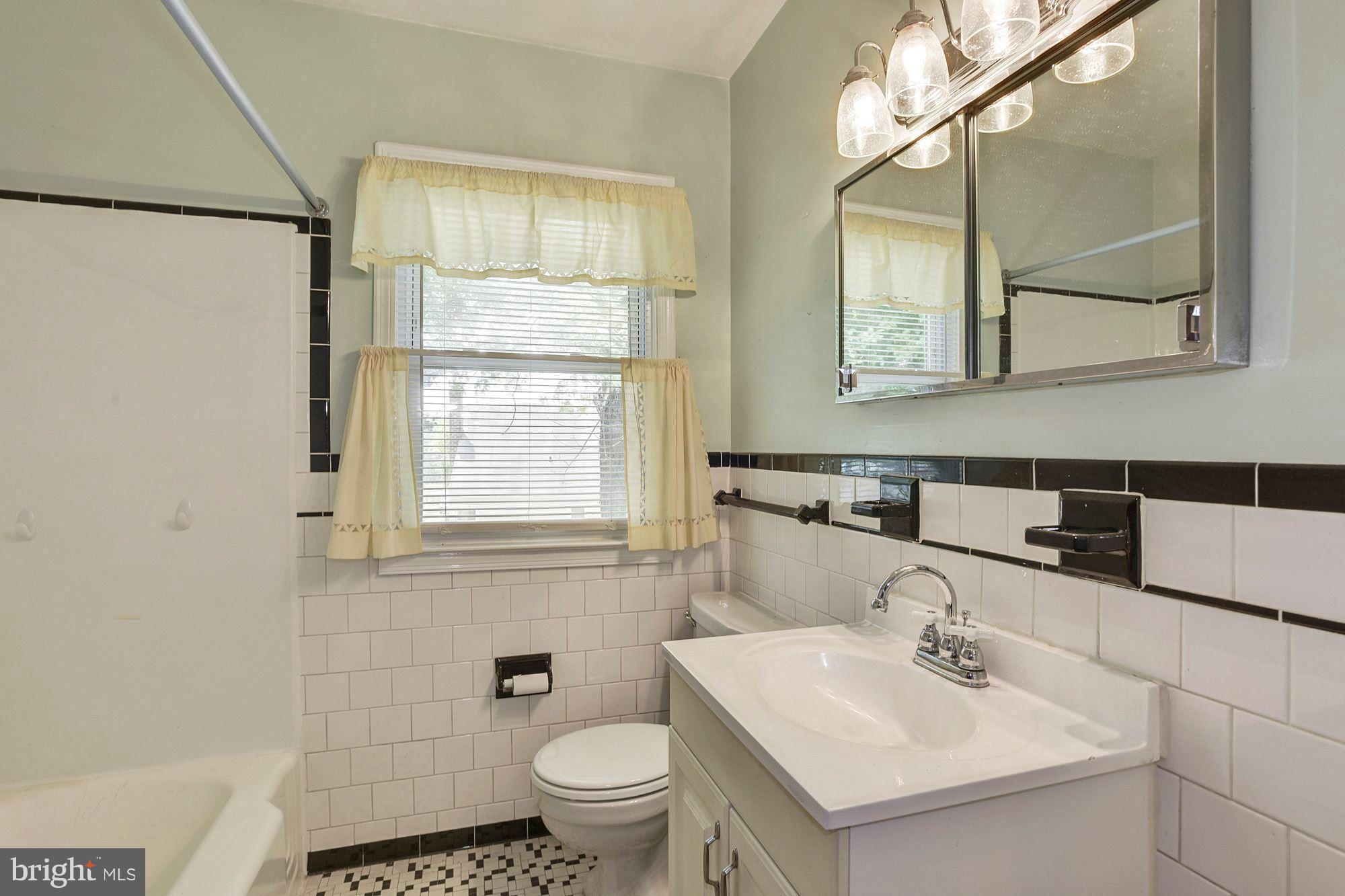 4613 Annapolis Road Baltimore, MD 21227 - Photo 9 of 15 a bathroom with a sink toilet and mirror