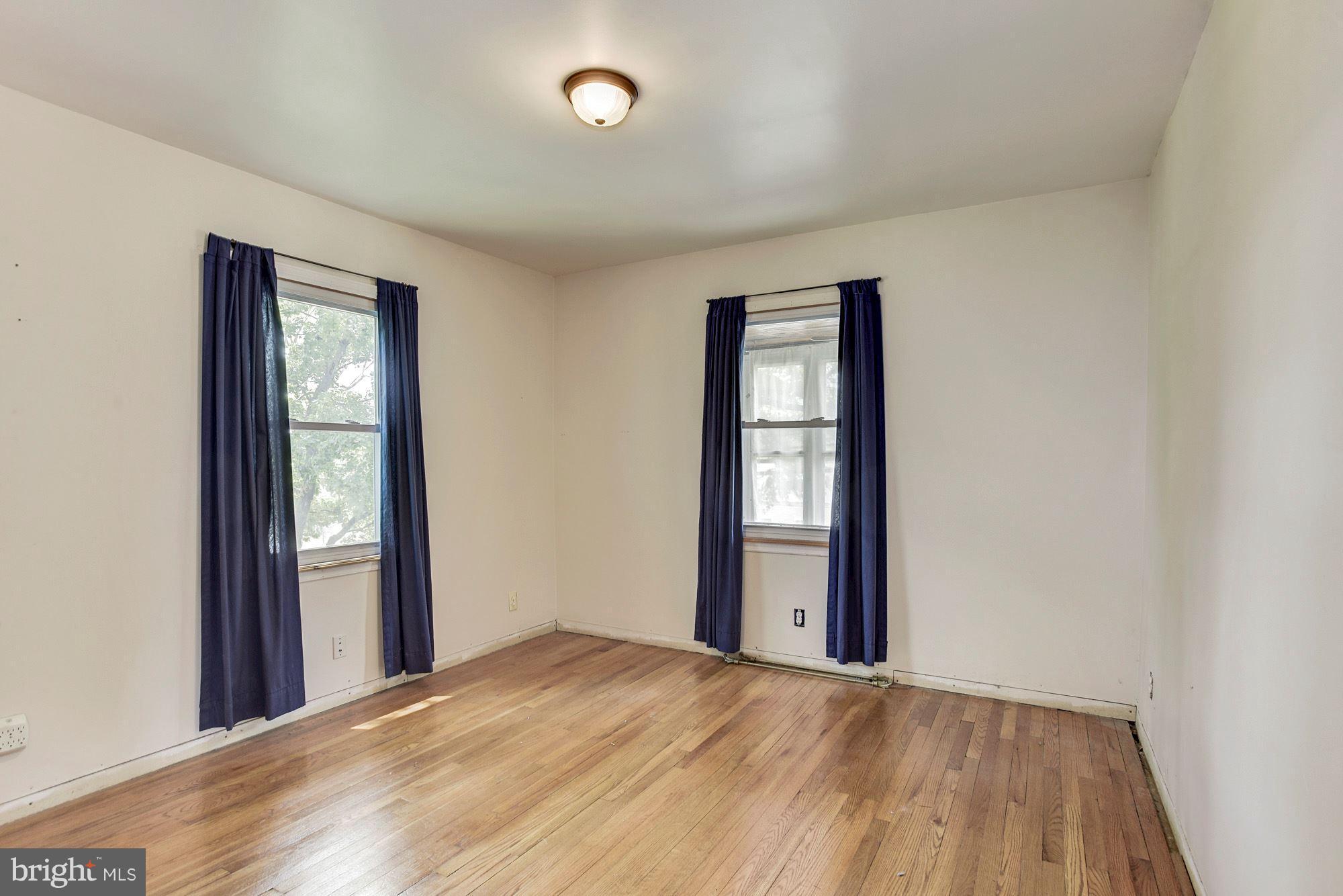 4613 Annapolis Road Baltimore, MD 21227 - Photo 10 of 15 an empty room with windows and closet