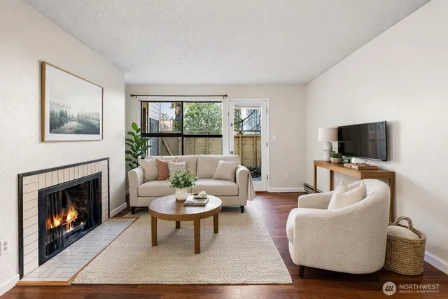 a living room with furniture a flat screen tv and a fireplace