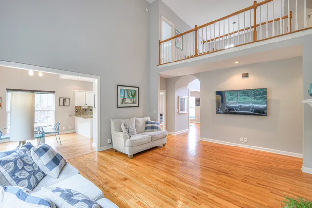 a dining room with wooden floor and large window