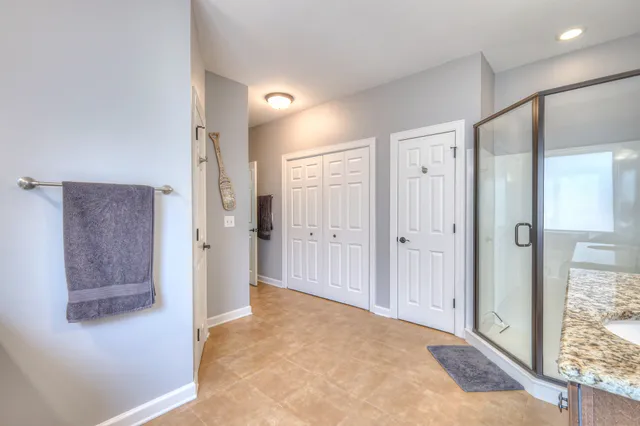 a spacious bedroom with a bed and a window