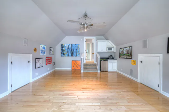 a view of a patio with table and chairs with wooden floor and fence