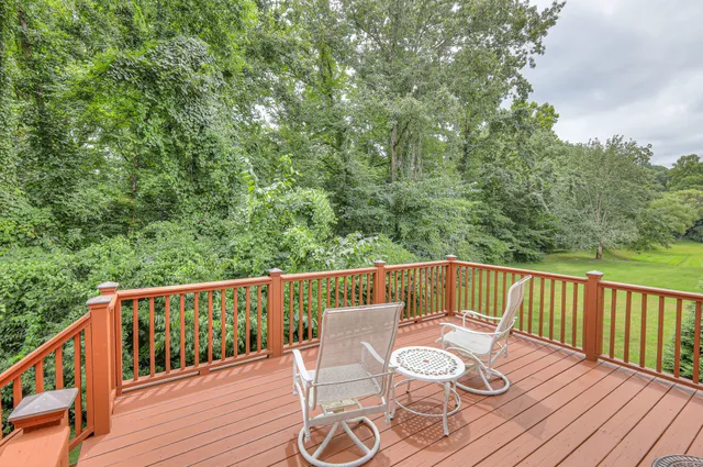 a view of a big house with a big yard and large trees