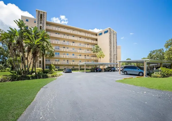 a view of a tall building with a yard