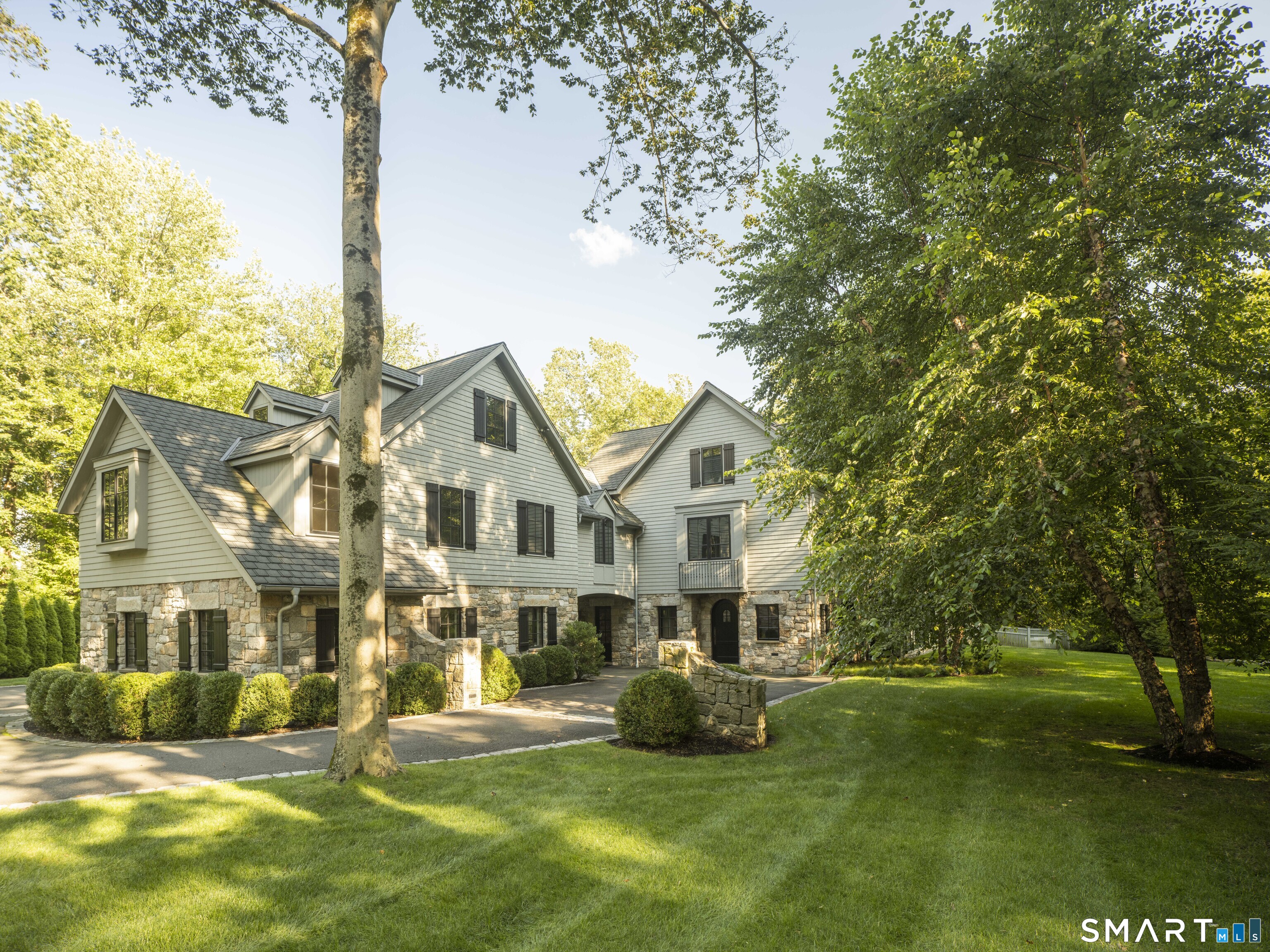 31 Stony Brook Road Westport, CT 06880 - Photo 35 of 36 a front view of a house with a garden and tree
