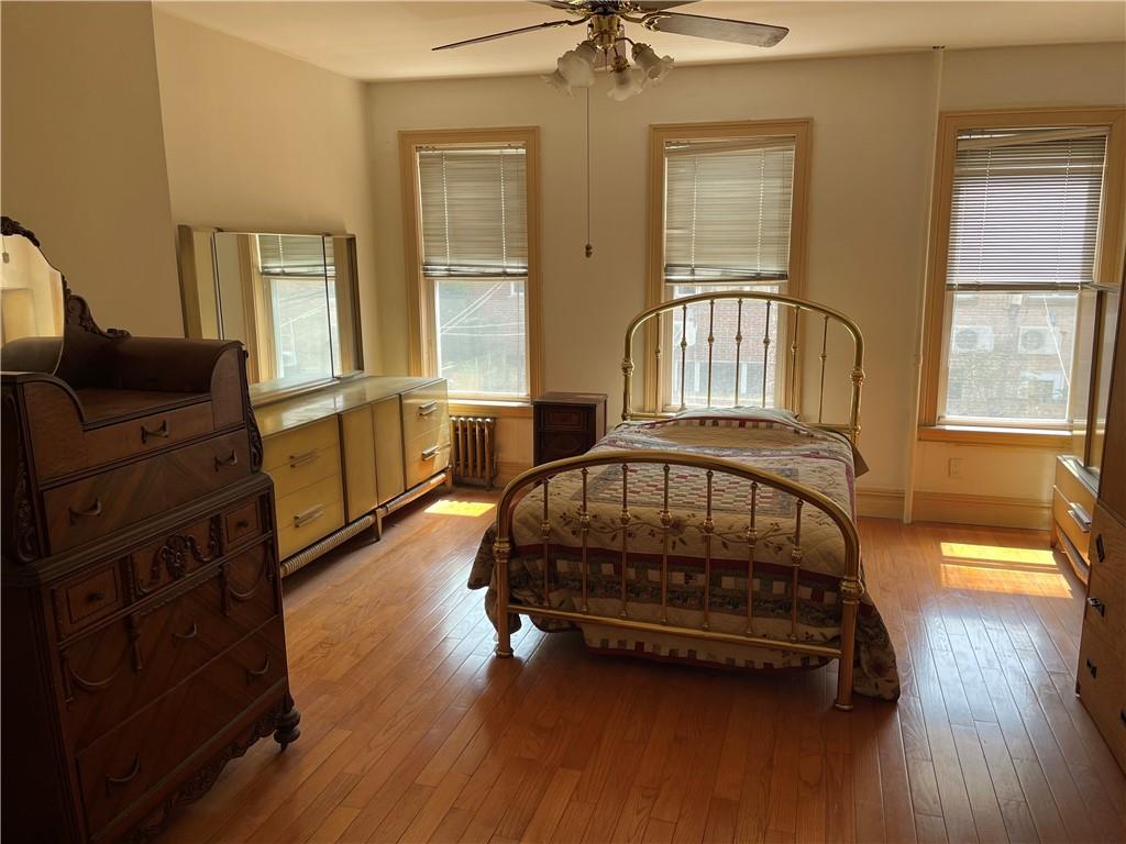 46 A Windsor Place Brooklyn, NY 11215 - Photo 16 of 24 a bedroom with a bed a dresser and wooden floor