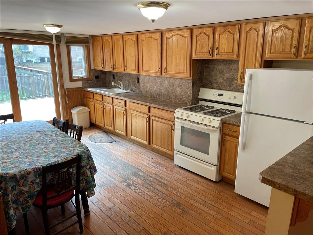 46 A Windsor Place Brooklyn, NY 11215 - Photo 19 of 24 a kitchen with a stove a sink and a refrigerator