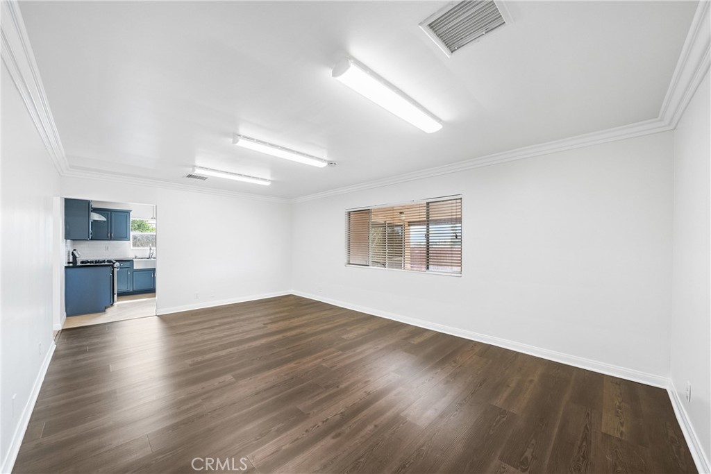 6331 Pedley Road Jurupa Valley, CA 92509 - Photo 34 of 45 an empty room with wooden floor and kitchen view