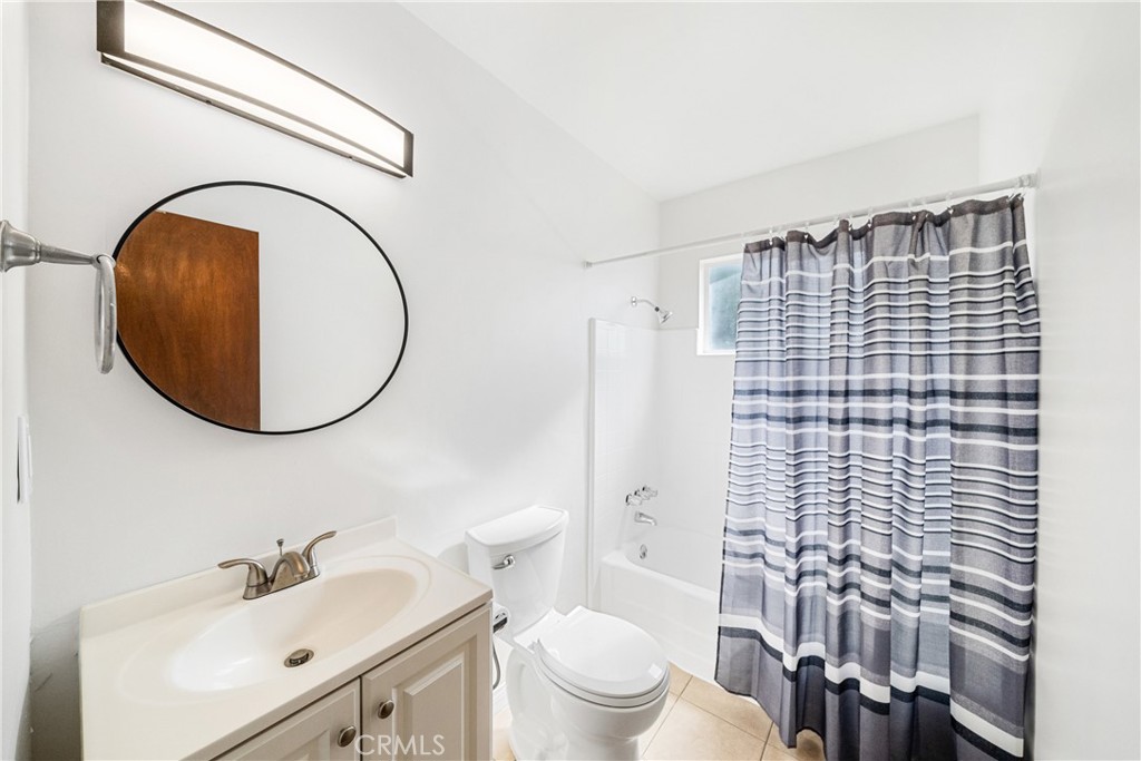 6331 Pedley Road Jurupa Valley, CA 92509 - Photo 41 of 45 a bathroom with a toilet a sink and a mirror
