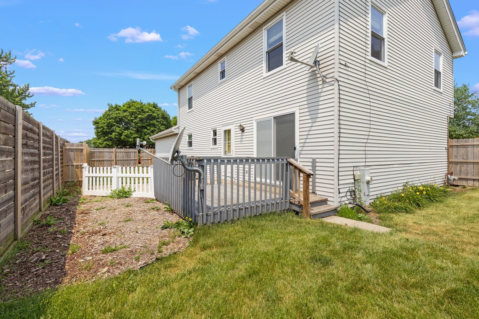 134 Meadows Drive Sugar Grove, IL 60554 - Photo 20 of 20 a view of a house with a small yard and wooden fence