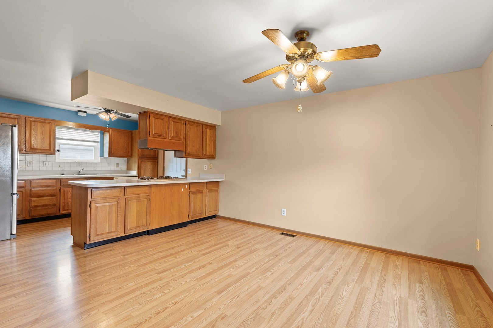 134 Meadows Drive Sugar Grove, IL 60554 - Photo 6 of 20 a kitchen with stainless steel appliances granite countertop a sink cabinets and wooden floor