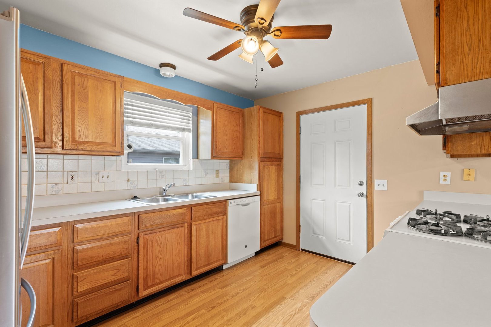 134 Meadows Drive Sugar Grove, IL 60554 - Photo 7 of 20 a kitchen with stainless steel appliances a sink a stove and a window