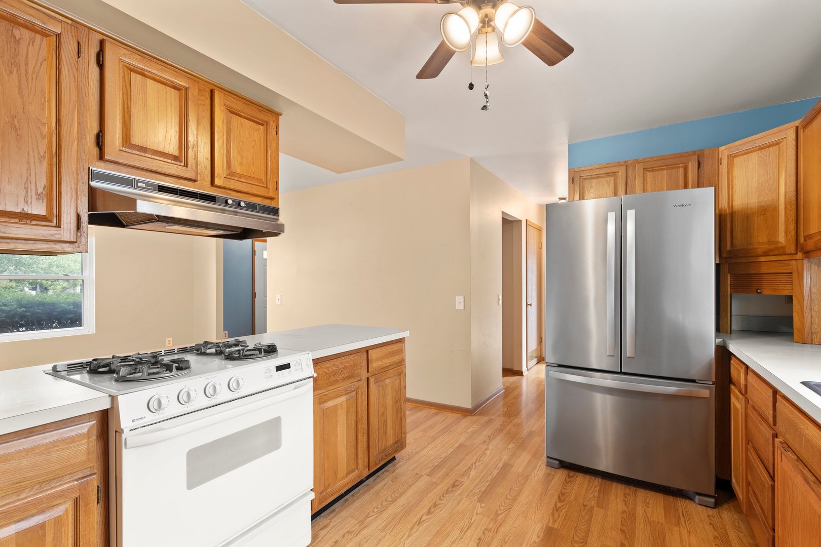 134 Meadows Drive Sugar Grove, IL 60554 - Photo 8 of 20 a kitchen with stainless steel appliances a refrigerator a stove and white cabinets