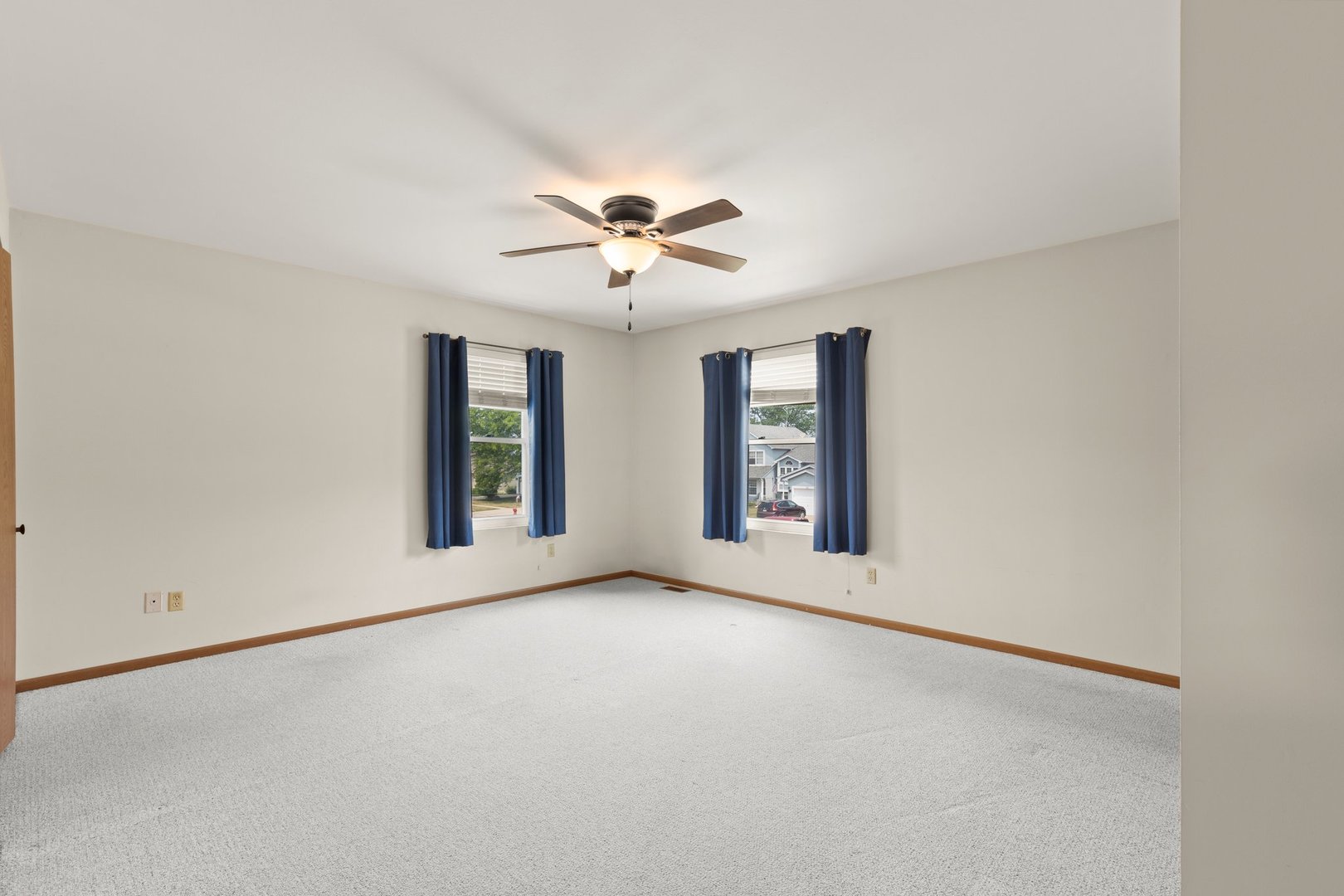 134 Meadows Drive Sugar Grove, IL 60554 - Photo 9 of 20 an empty room with chandelier fan and windows