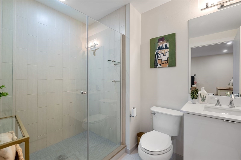121 Portland Street, Unit 605 Boston, MA 02114 - Photo 10 of 19 a white toilet sitting next to a bathroom sink