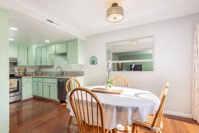 a dining room with furniture and wooden floor