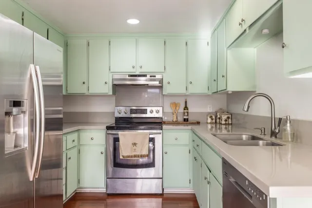 a kitchen with stainless steel appliances granite countertop a sink stove and refrigerator