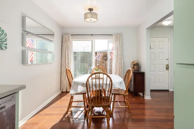 a view of a dining room with furniture window and wooden floor