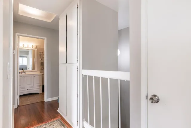 a view of a hallway with wooden floor