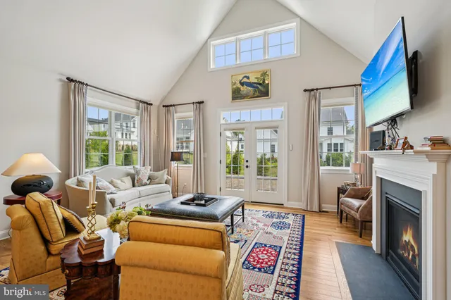 a living room with furniture a fireplace and a large window