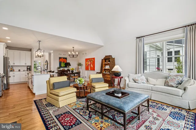a living room with furniture a rug and a large window